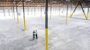  Architects talk about blueprint in an empty warehouse building