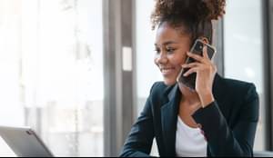 Attractive young business woman african american stock market trader and research solutions for online brokerage, clearing firms, banks, media portals, public companies